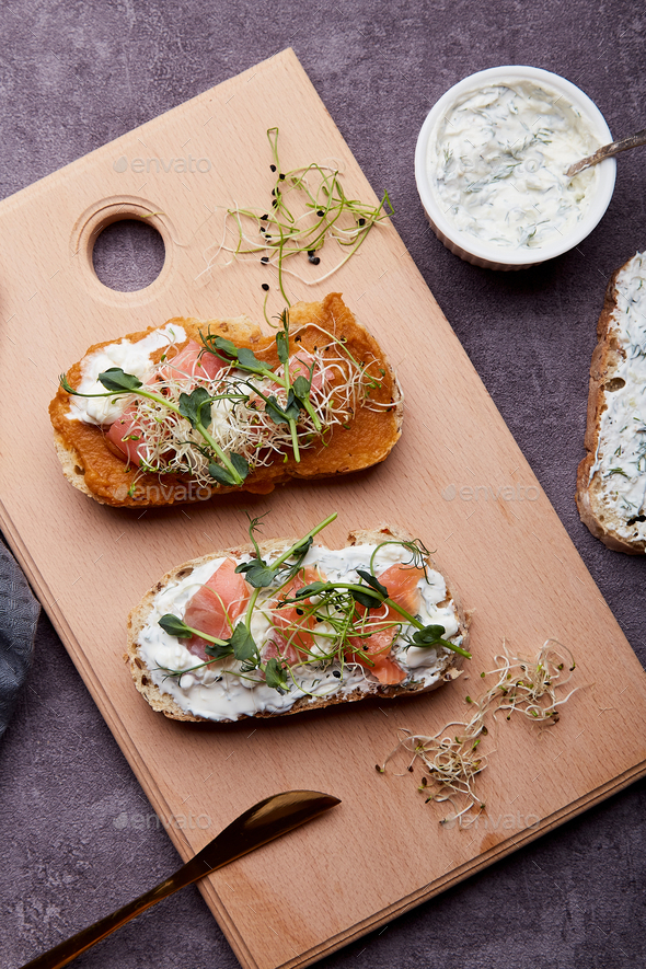 Sandwiches with zucchini and cream cheese spread, salmon, sprouted peas